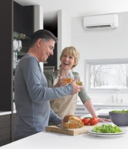 man and woman in room with ductless mini split system installation