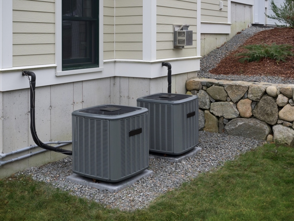 air conditioning units attached to house in yard
